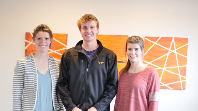 HVS Motors image of three people in front of company sign